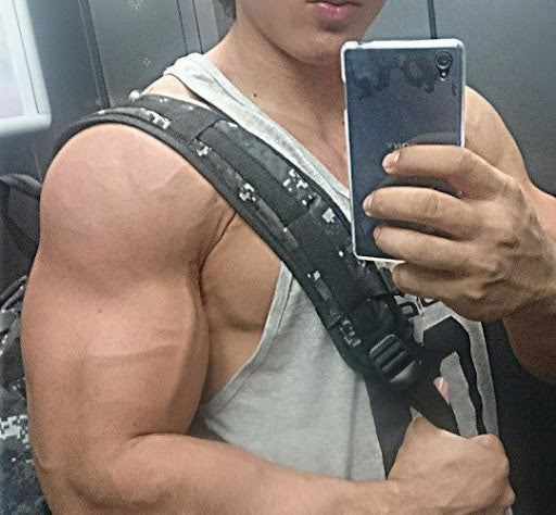 Guy flexing his biceps in a mirror picture